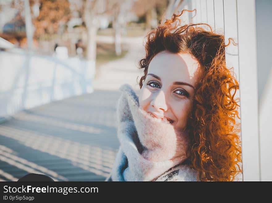 Women Leaning on White Wooden Fence Wearing Gray Furred Top