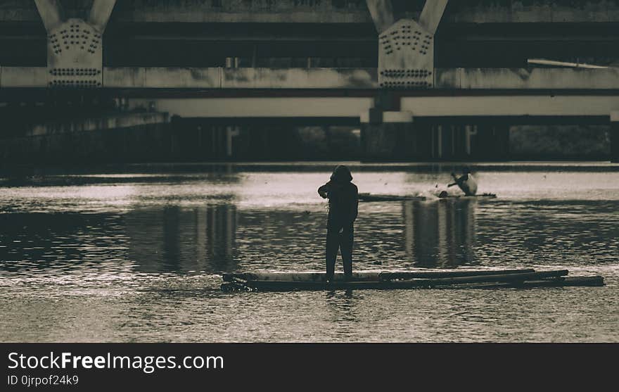 Grayscale Photography of a Woman Beside Body of Water