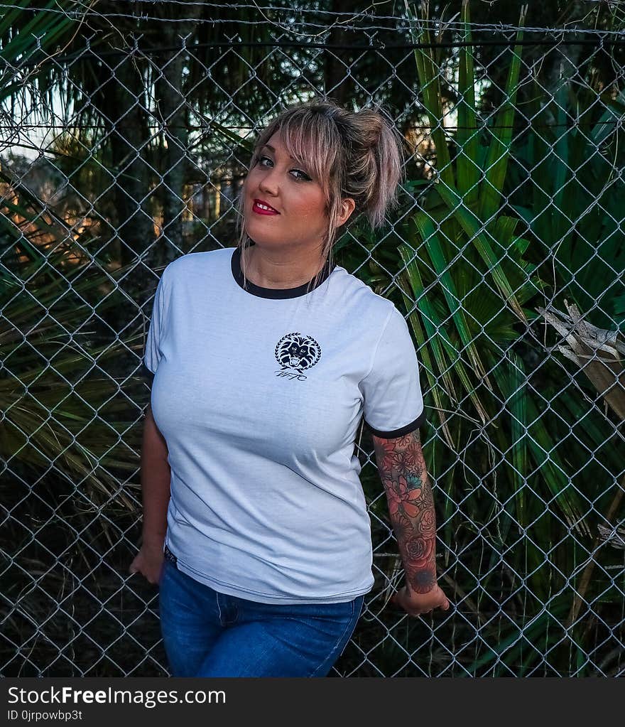 Photo of Woman Wearing White Ringer Tee and Blue Jeans