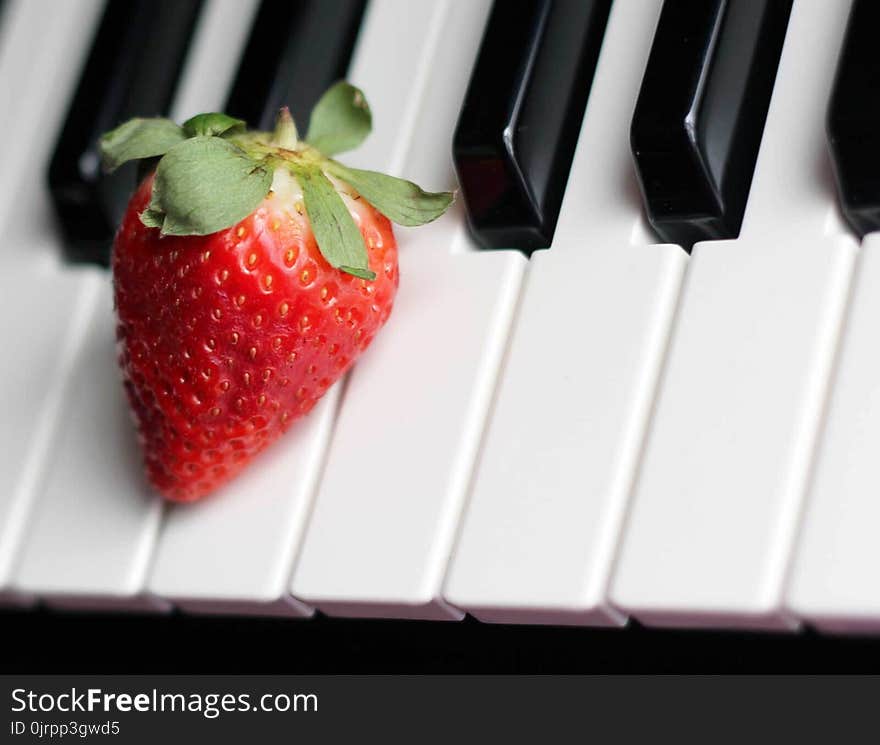 Strawberry on Top of Piano Keys