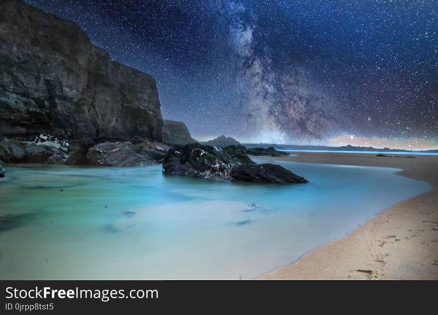 Black Stone on Body of Water during Nighttime