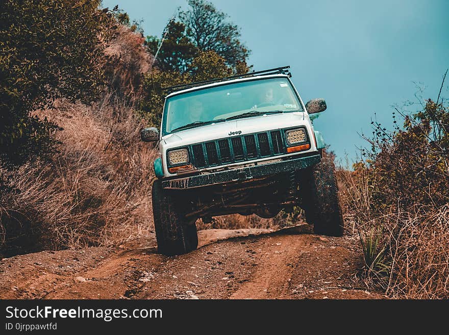 White Jeep Suv Cruising Down the Road