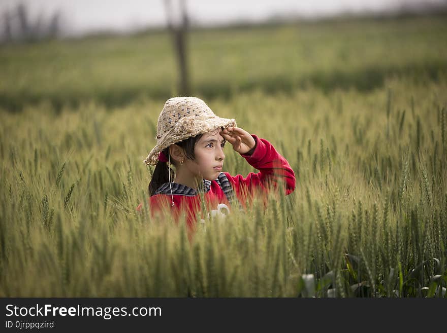 Girl in Red Hoodie Wearing Beige Sunhat