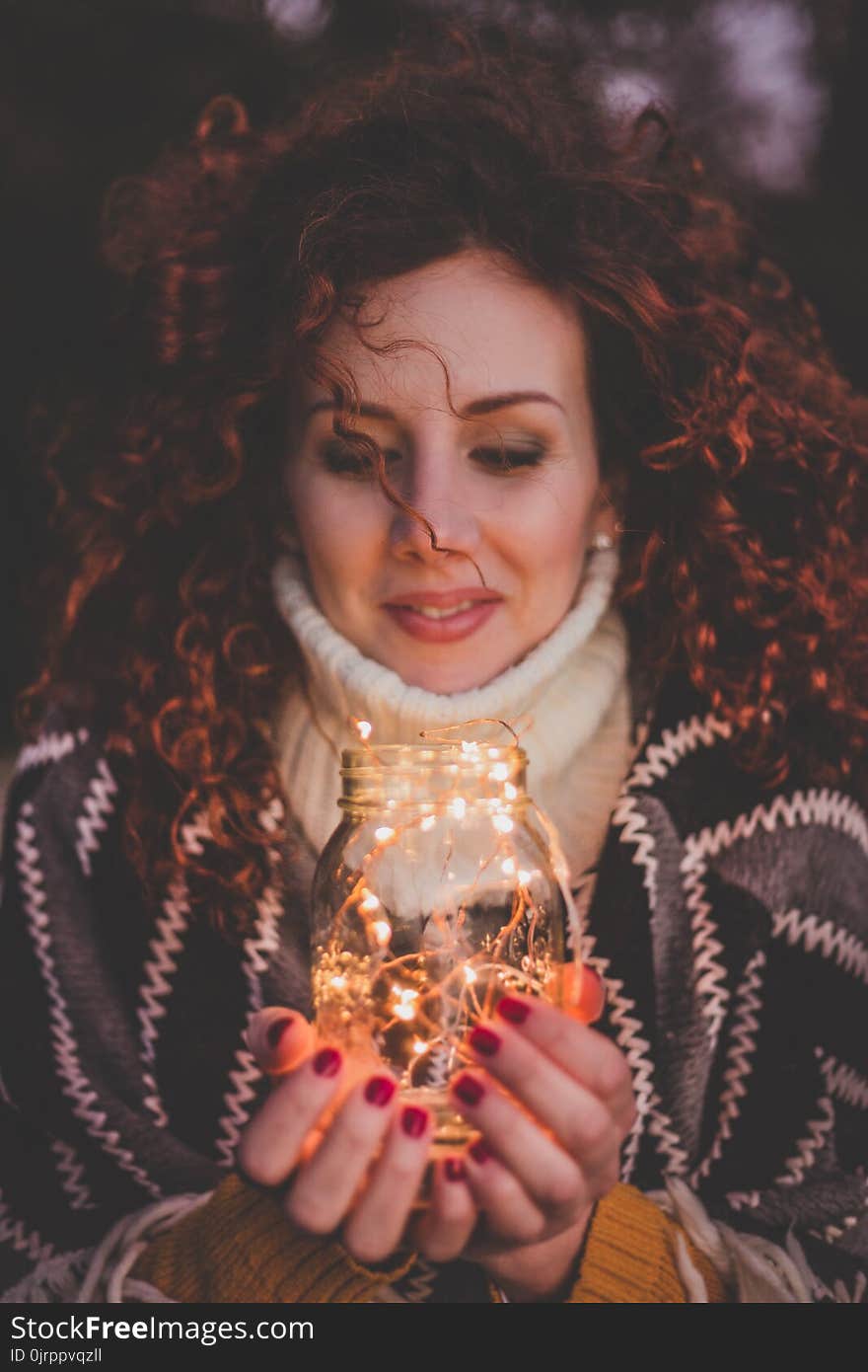 Woman Holding Mason Jar With String Lights Inside