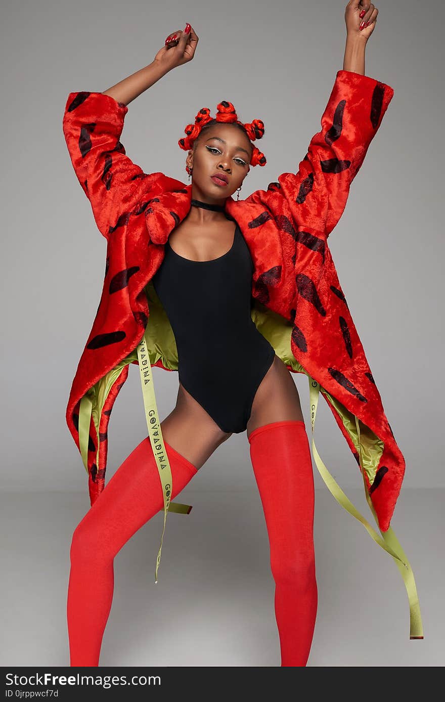 Woman in Red Coat Wearing Monokini and Red Stockings