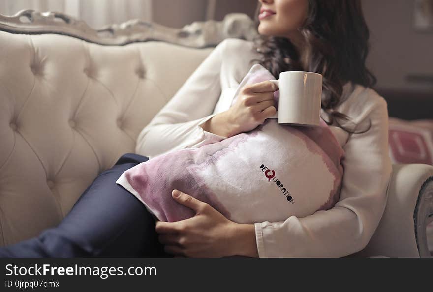 Woman in White Long-sleeved Shirt Holding White Ceramic Mug