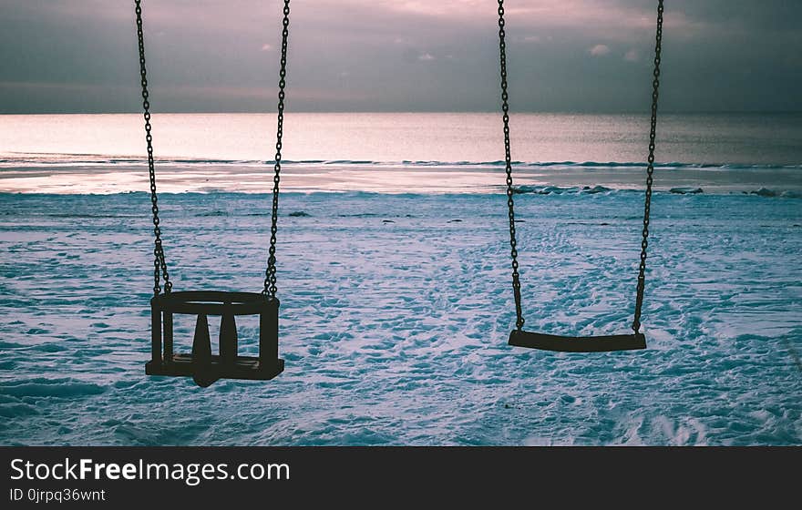 Silhouette Photo of Two Swings