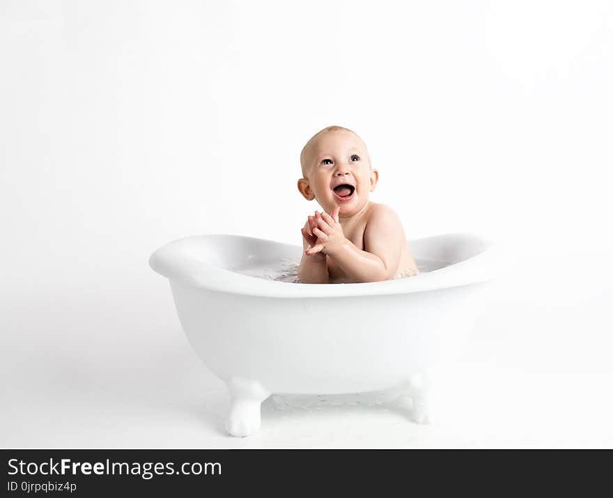 Baby Inside White Bathtub With Water