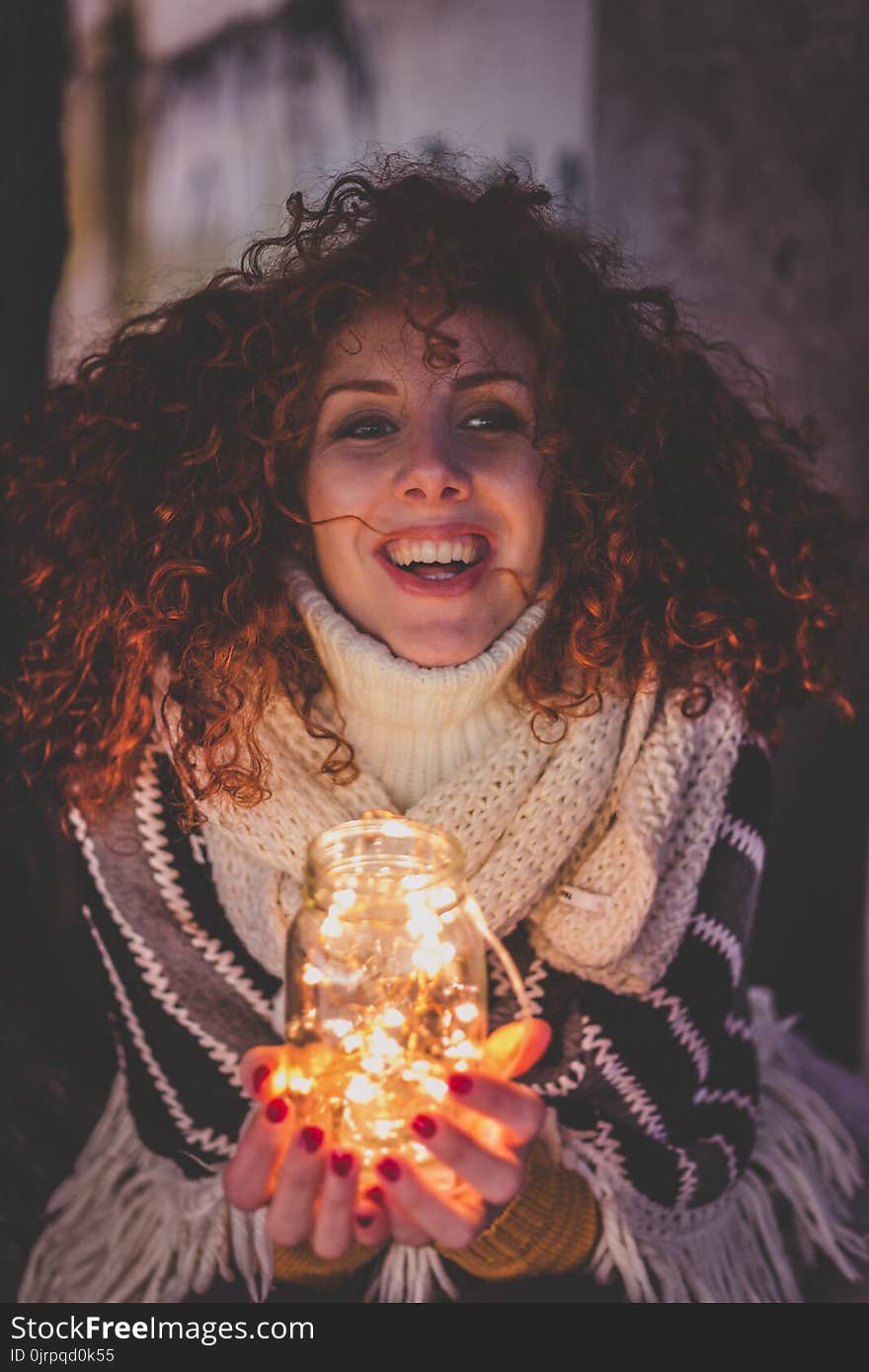 Woman Holding a Jar With String Lights