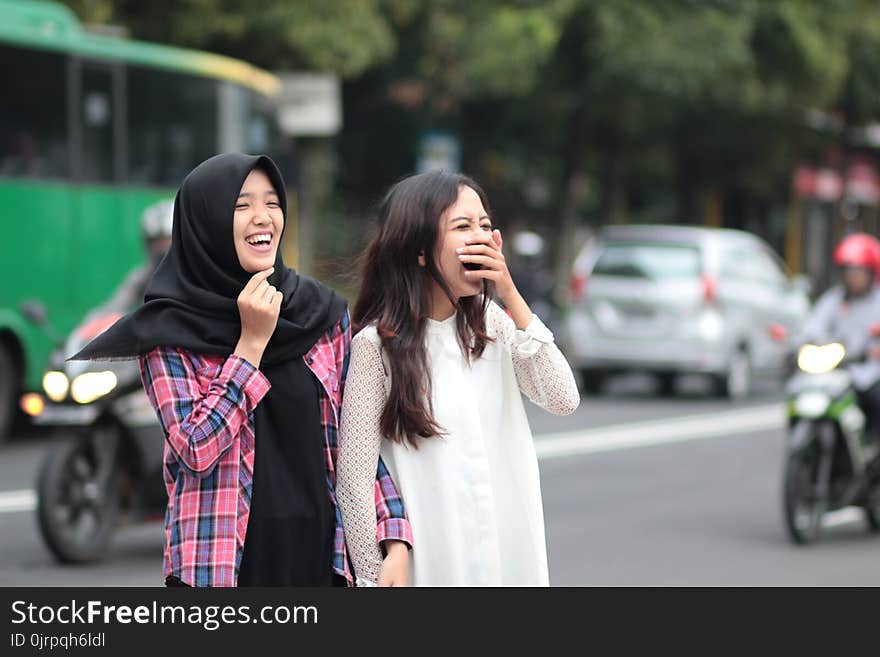 Two Women Laughing at Street