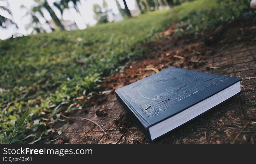 Black Book on Brown Floor