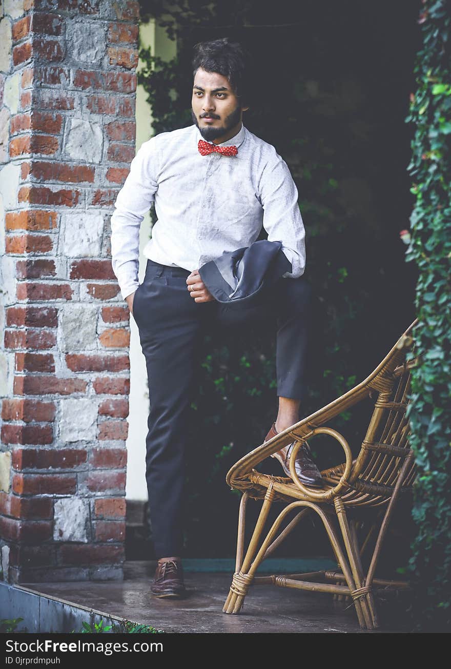 Photo of Man in White Shirt and Black Pants