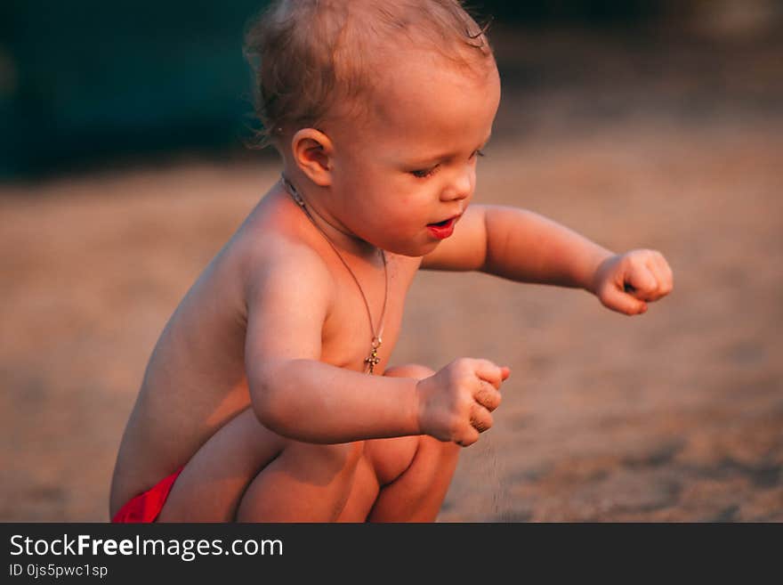 Toddler Playing With Sand