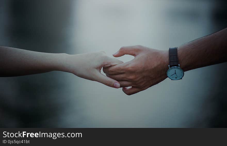 Photo of Two Persons Holding Hands