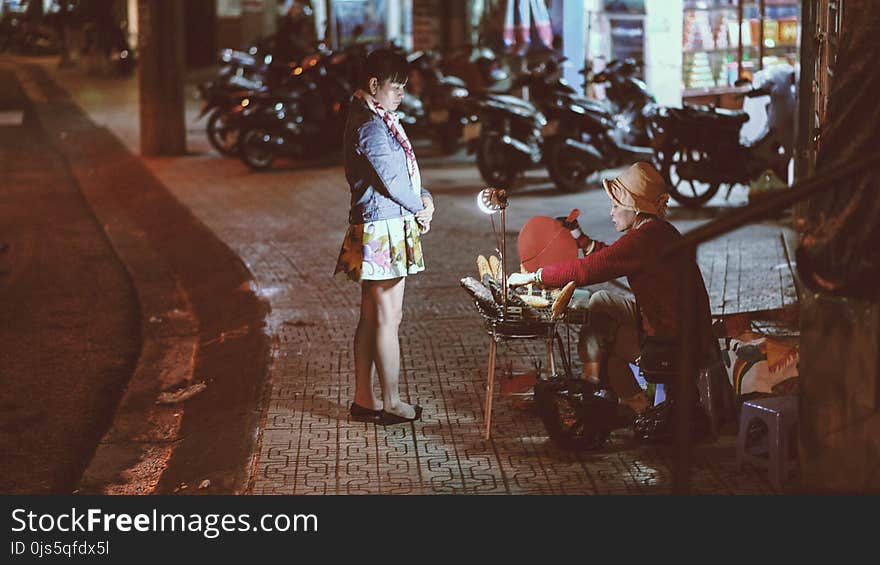 Woman buying from a street vendor