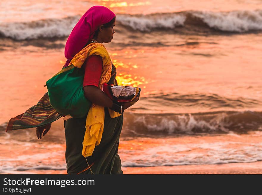 Woman Holding Grey Bowl Near Seaside