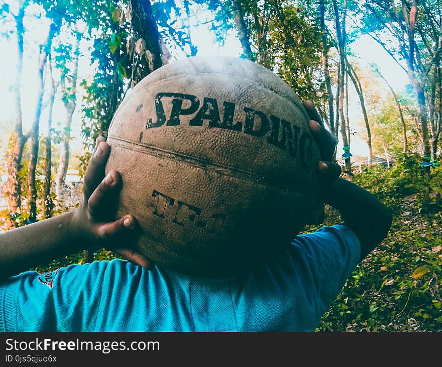 Person Holding Brown Spalding Basketball