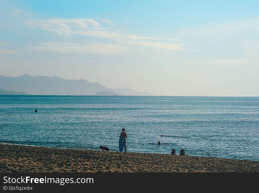 Person Standing on Seashore