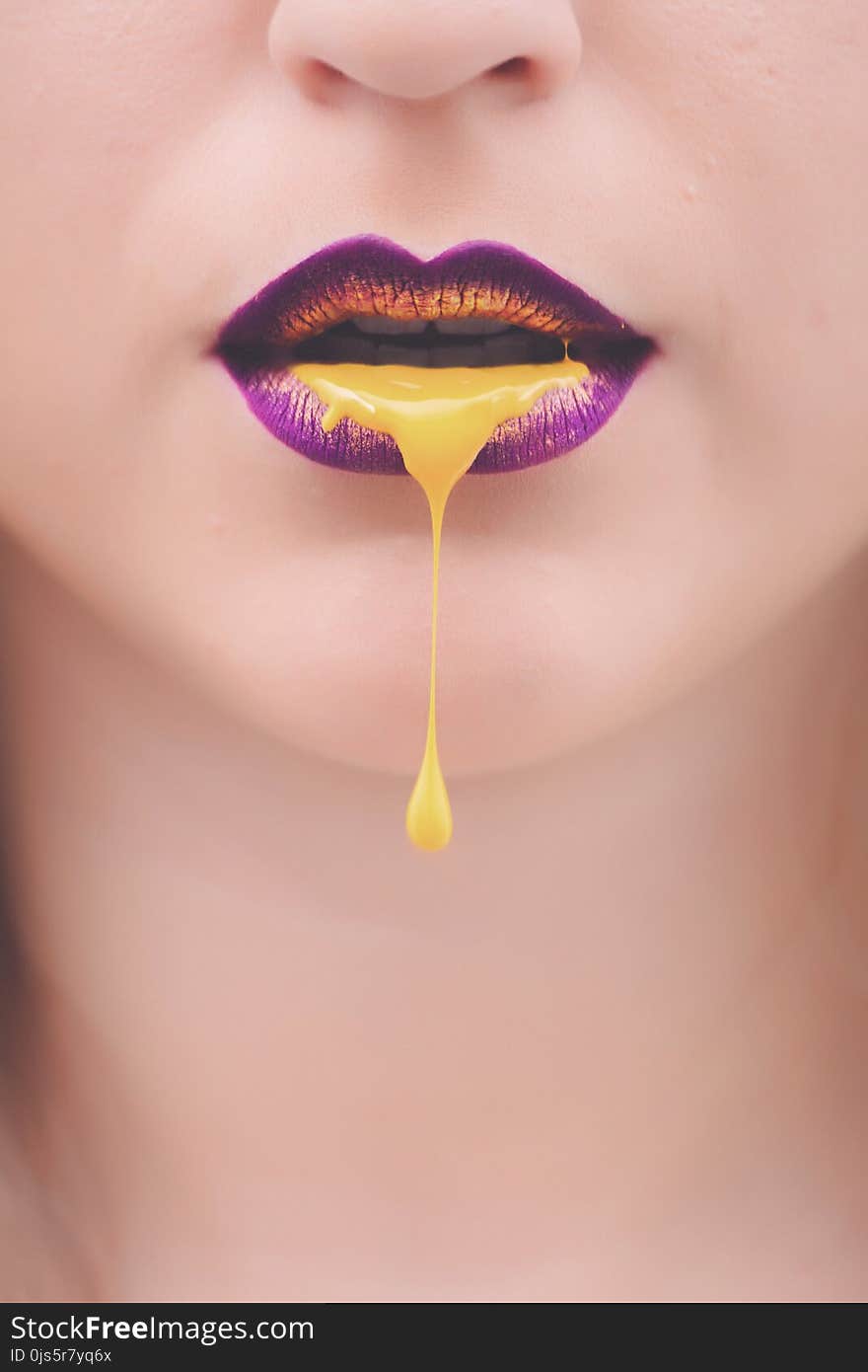 Women&#x27;s Purple and Yellow Lips With Yellow Liquid