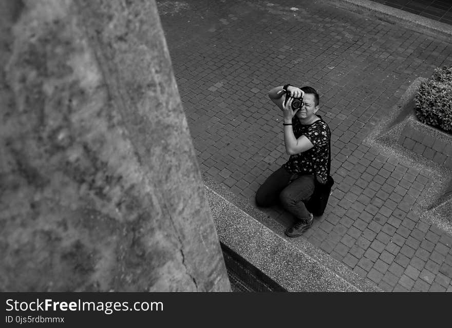 Grayscale Photography of Man Taking Picture