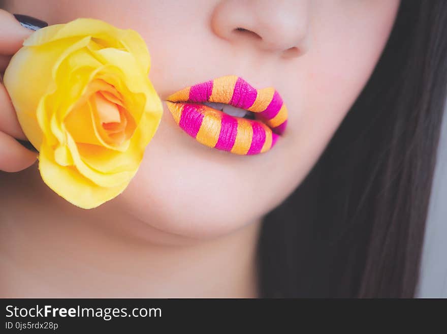 Woman Wearing Pink and Yellow Stripe Lipstick