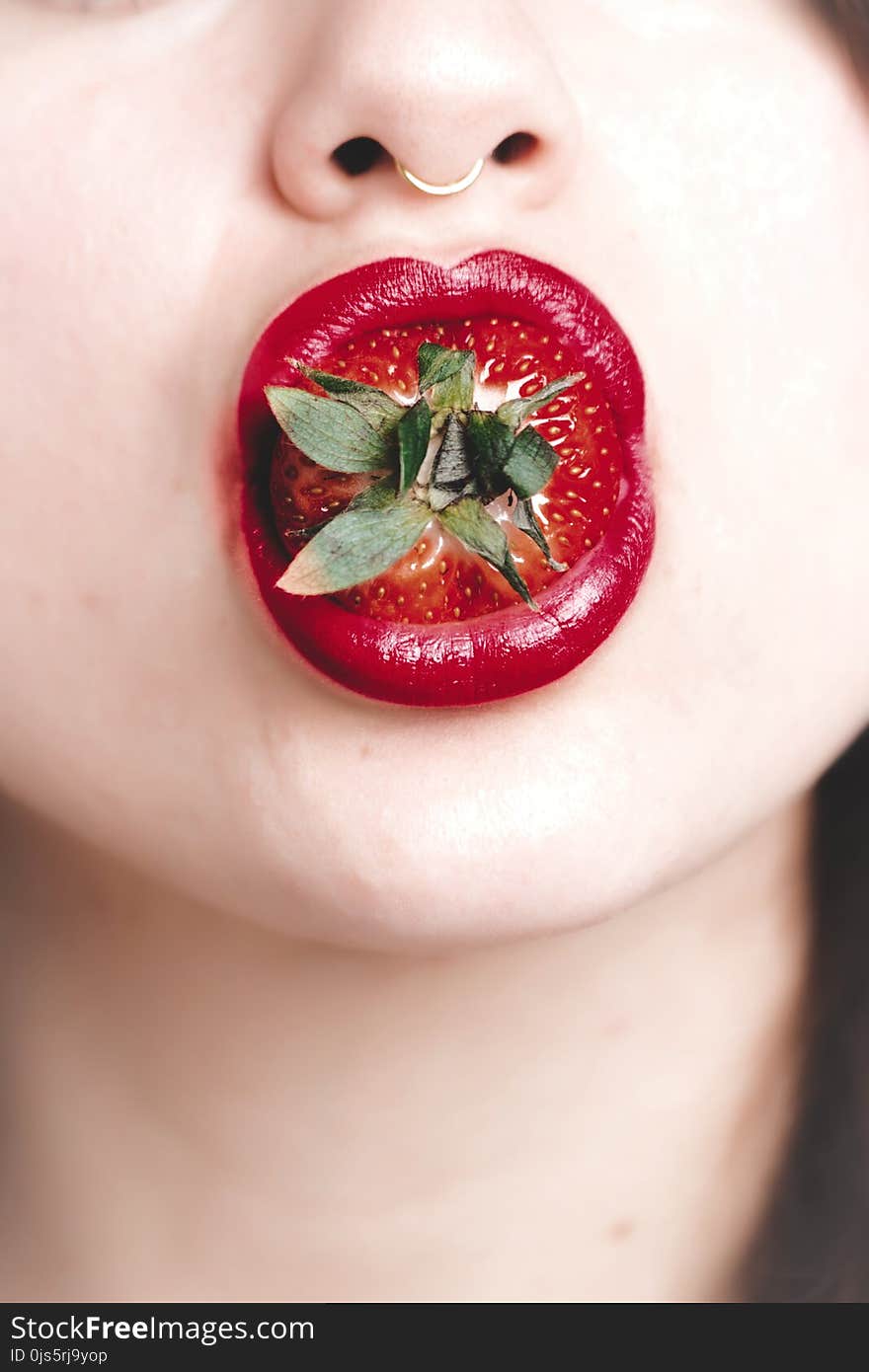 Woman With Strawberry on Mouth