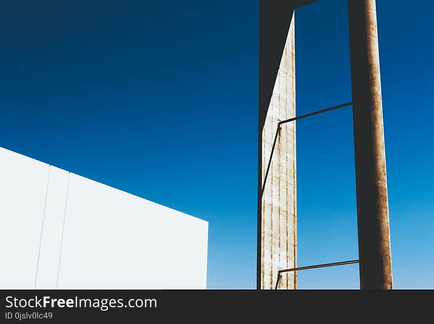 White and Brown Steel Tube Near White Wall