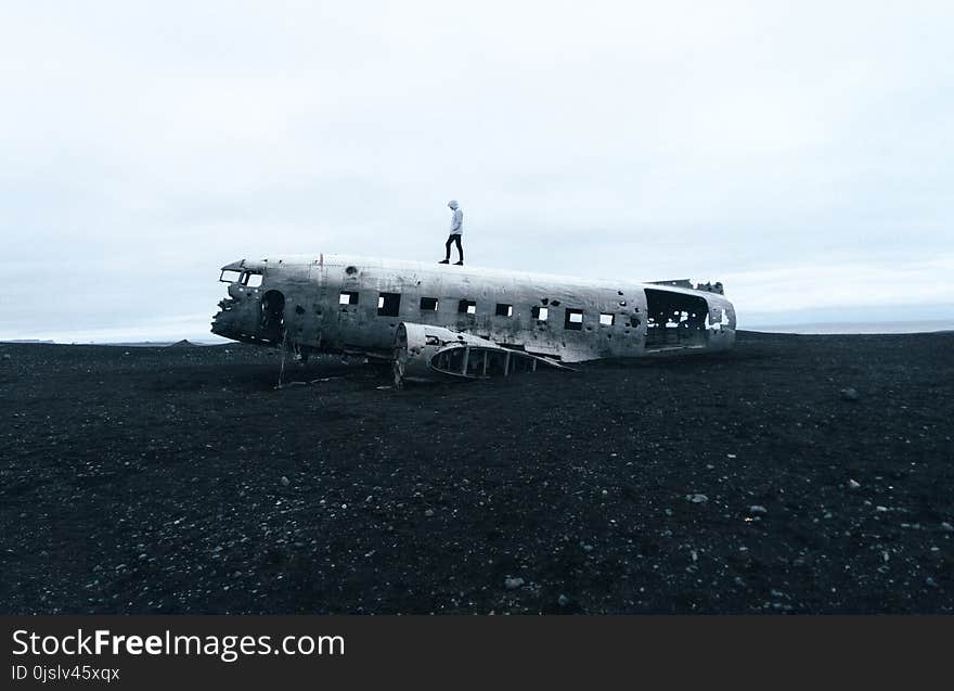 Person Standing on Wrecked Plane