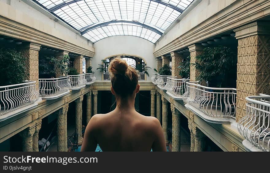 Woman Standing Beside White Fence