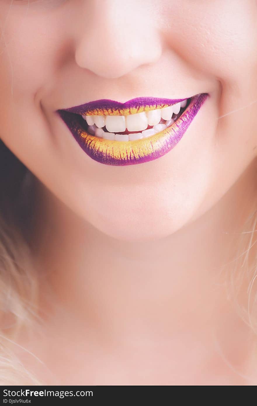 Woman Showing Her Purple and Yellow Lipsticks