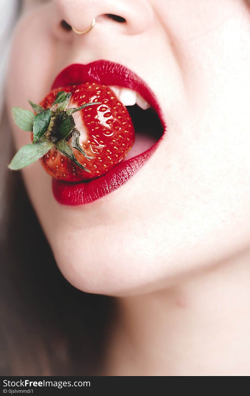 Woman With Red Lipstick Biting Strawberry