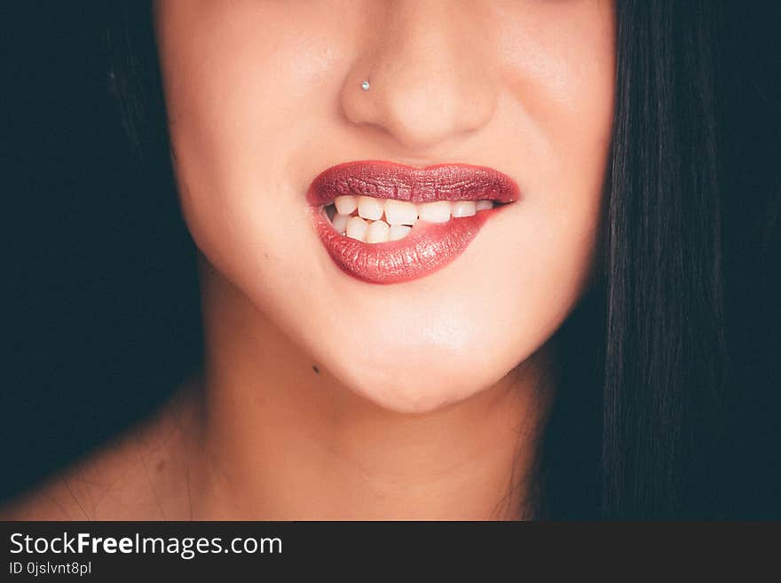 Woman Biting Red Lips With Nose Pin