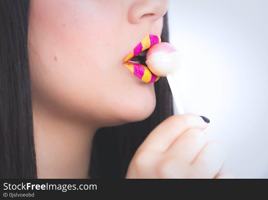 Woman Holding a Lollipop