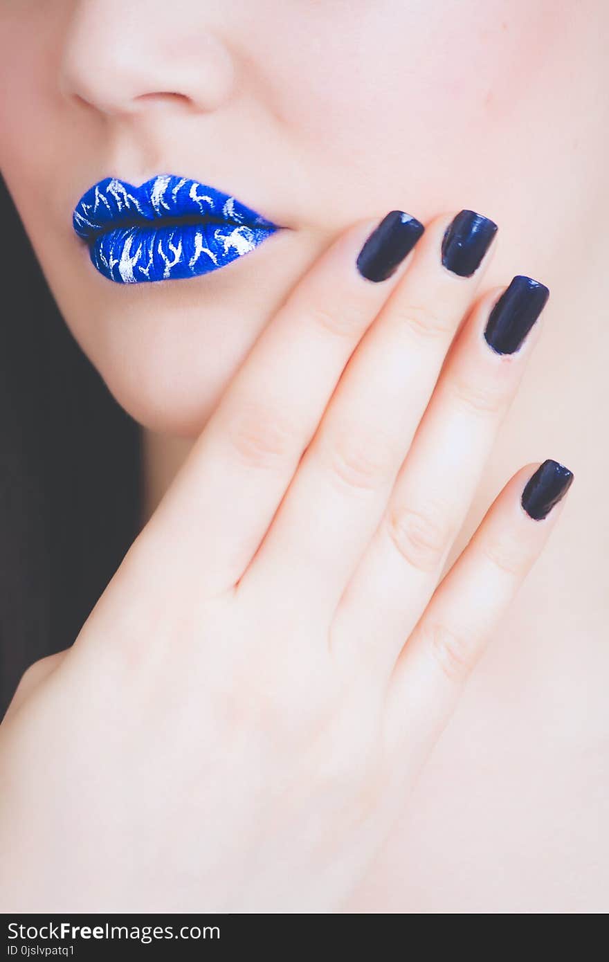 Woman Wearing Blue and White Lipstick With Black Manicure