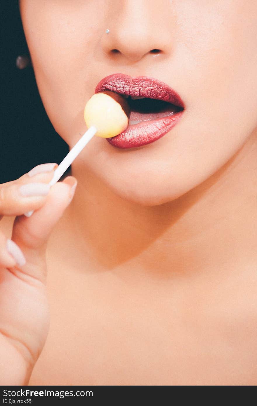 Woman With Red Lipstick Licking a Lollipop