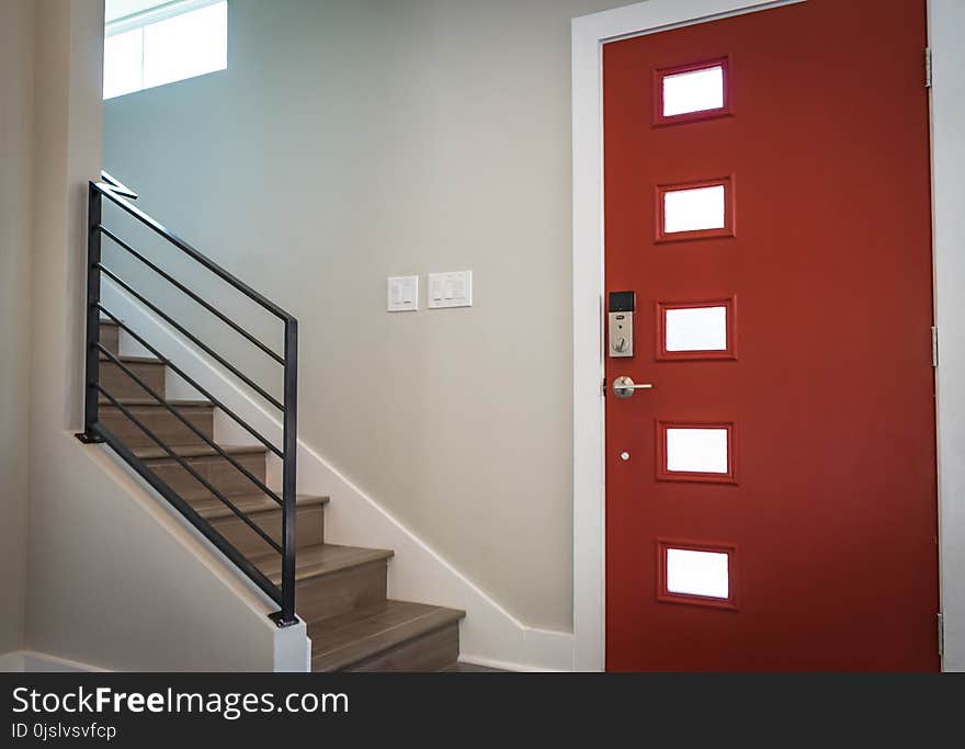 Red Wooden Door Beside Stairs