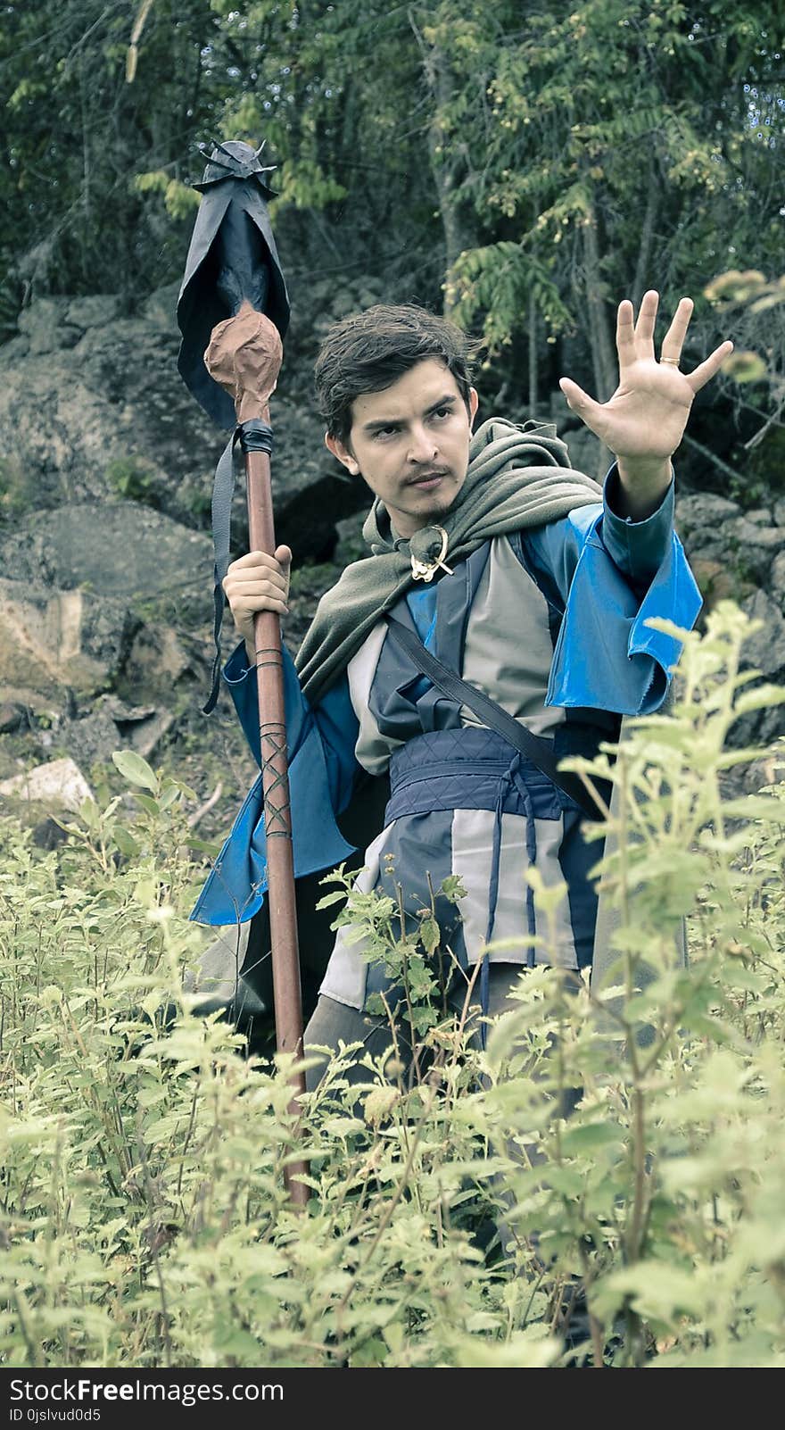 Man With Costume Holding Rod