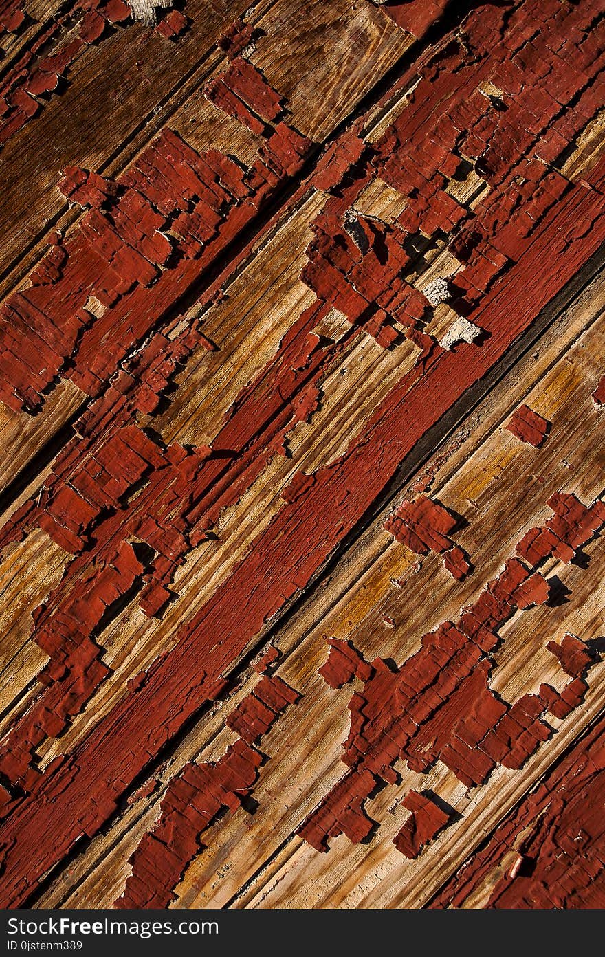 View of red chipped paint on aged wood texture at the abandoned Newport Mill in Newport, Kentucky. View of red chipped paint on aged wood texture at the abandoned Newport Mill in Newport, Kentucky.