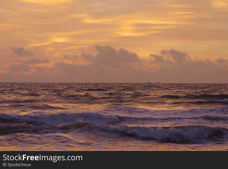 Sri-Lanka beach. red sunset at the ocean. cloudy.