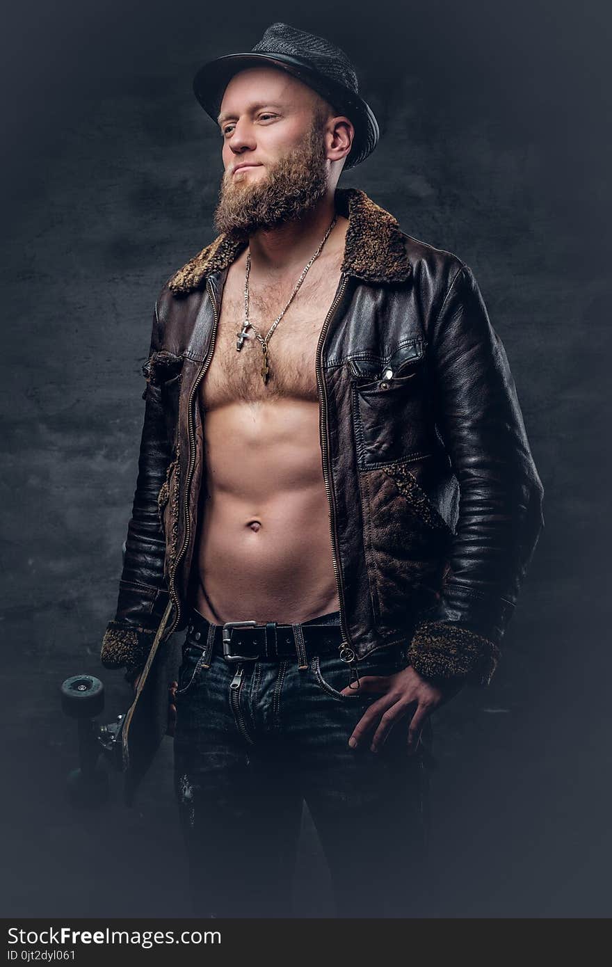 Bearded Man Wearing A Leather Jacket On Naked Torso.