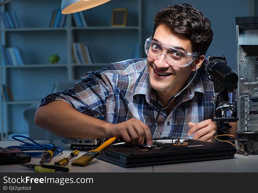 The computer repair concept with man inspecting with stethoscope