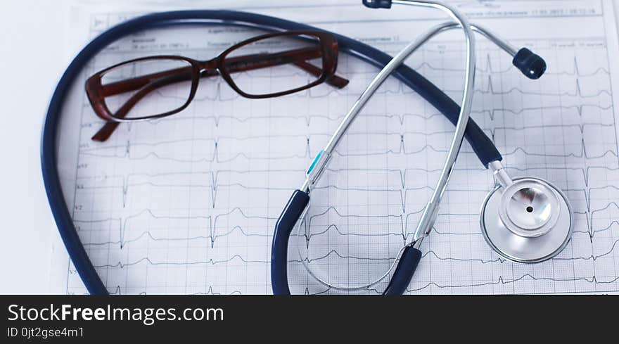 Stethoscope On Cardiogram Concept For Heart Care On The Desk.blue Toned Images