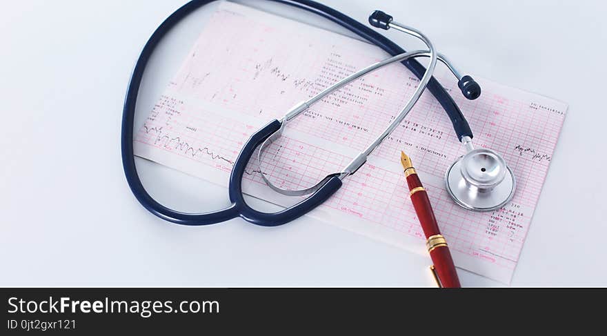 Stethoscope On Cardiogram Concept For Heart Care On The Desk.blue Toned Images