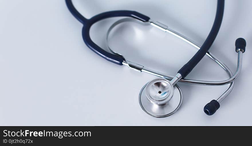 Stethoscope on cardiogram concept for heart care on the desk.blue toned images