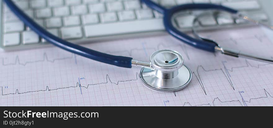 Stethoscope On Cardiogram Concept For Heart Care On The Desk.blue Toned Images