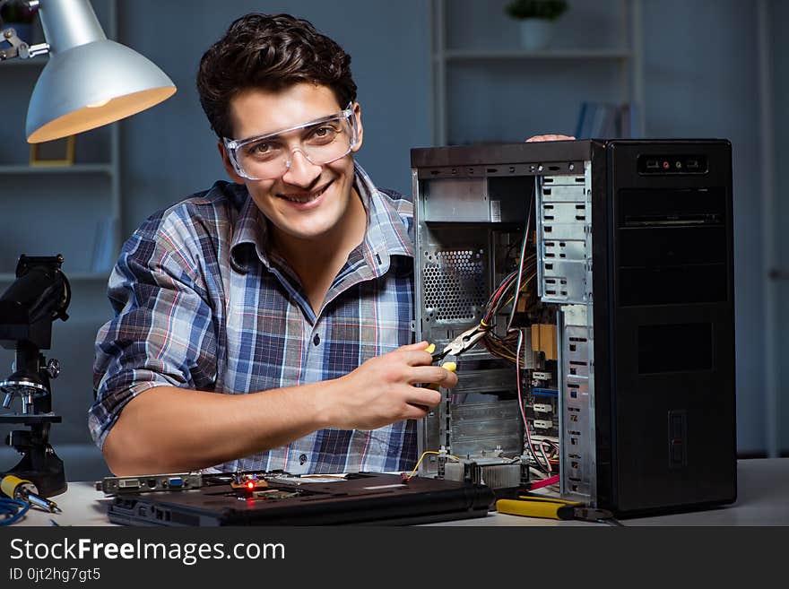 The man repairing computer desktop with pliers