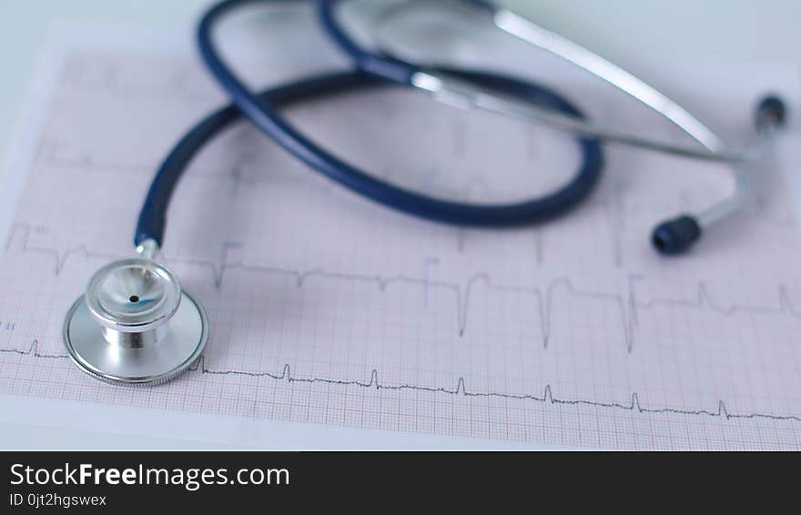 Stethoscope On Cardiogram Concept For Heart Care On The Desk.blue Toned Images