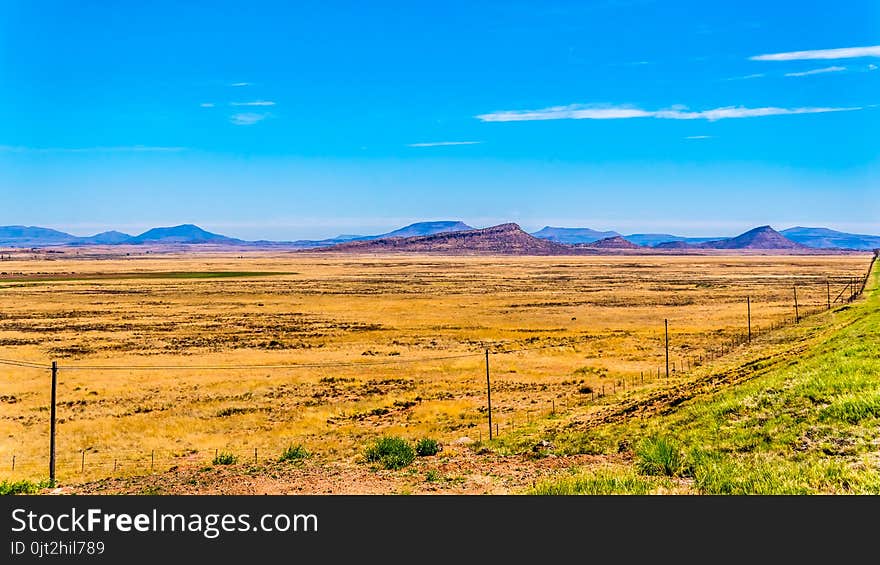 Endless wide open landscape of the semi desert Karoo Region in Free State and Eastern Cape provinces in South Africa under blue sky