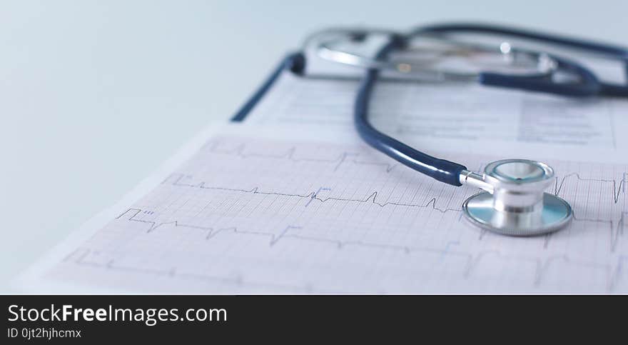 Stethoscope On Cardiogram Concept For Heart Care On The Desk.blue Toned Images