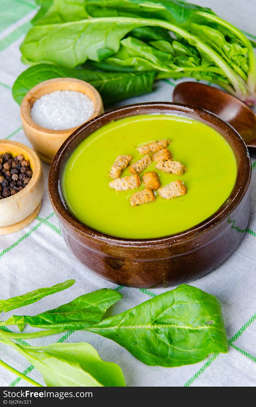 The spinach soup served on wooden board